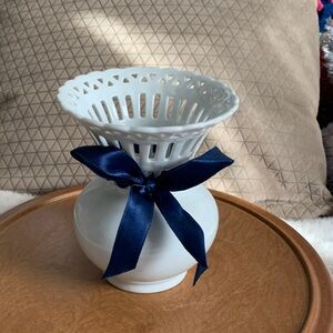 Mikasa Bridal Lace vase with blue ribbon made of white glazed porcelain.